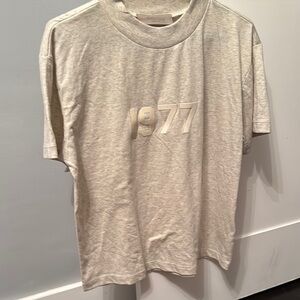 Essential Fear of God
1977 Graphic T-Shirt in Light Gray